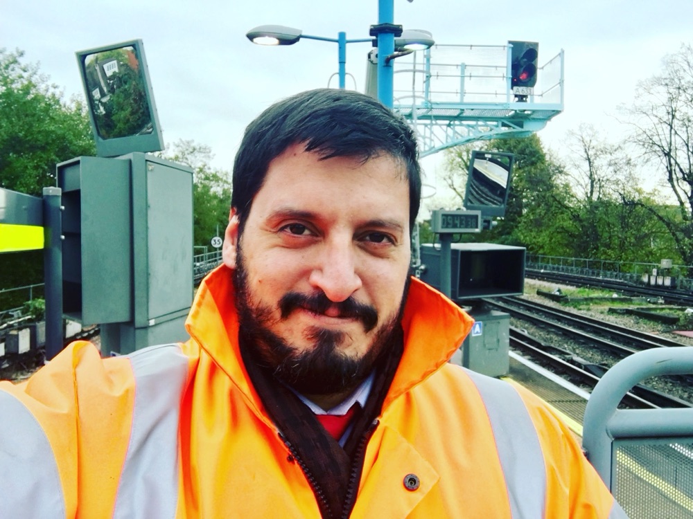 Joe Del Prado on a railway platform with signalling equipment